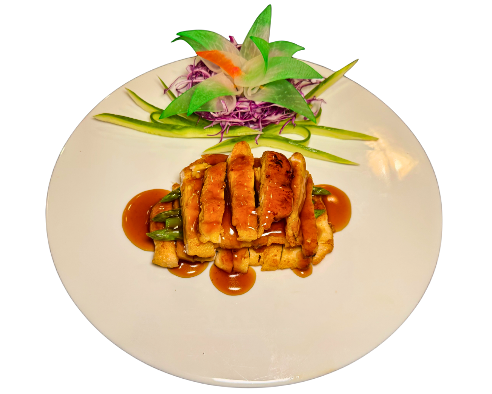 Glazed teriyaki chicken with fresh vegetable garnish at SOHO Asian Fusion, a Asian Fusion Restaurant in Austin.