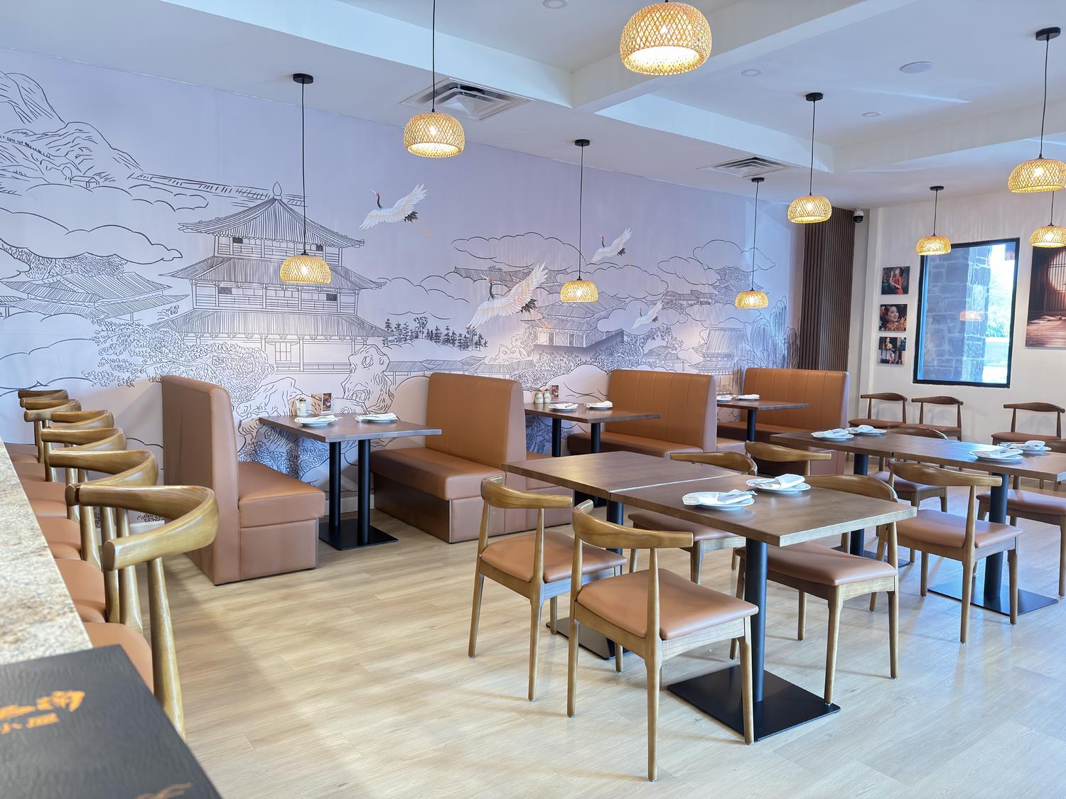 Modern restaurant interior with crane murals, booth seating, and woven lights at SoHo Asian Fusion, a Asian fusion restaurant in Austin