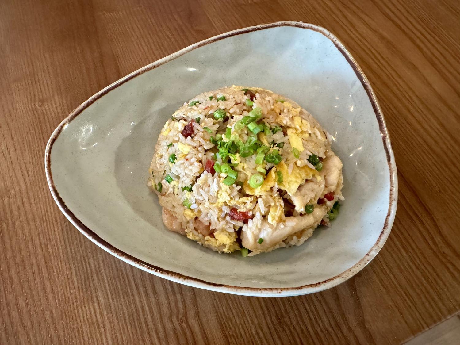 Fried rice with chicken, egg, and scallions served in a light ceramic bowl at SoHo Asian Fusion, a Asian fusion restaurant in Austin