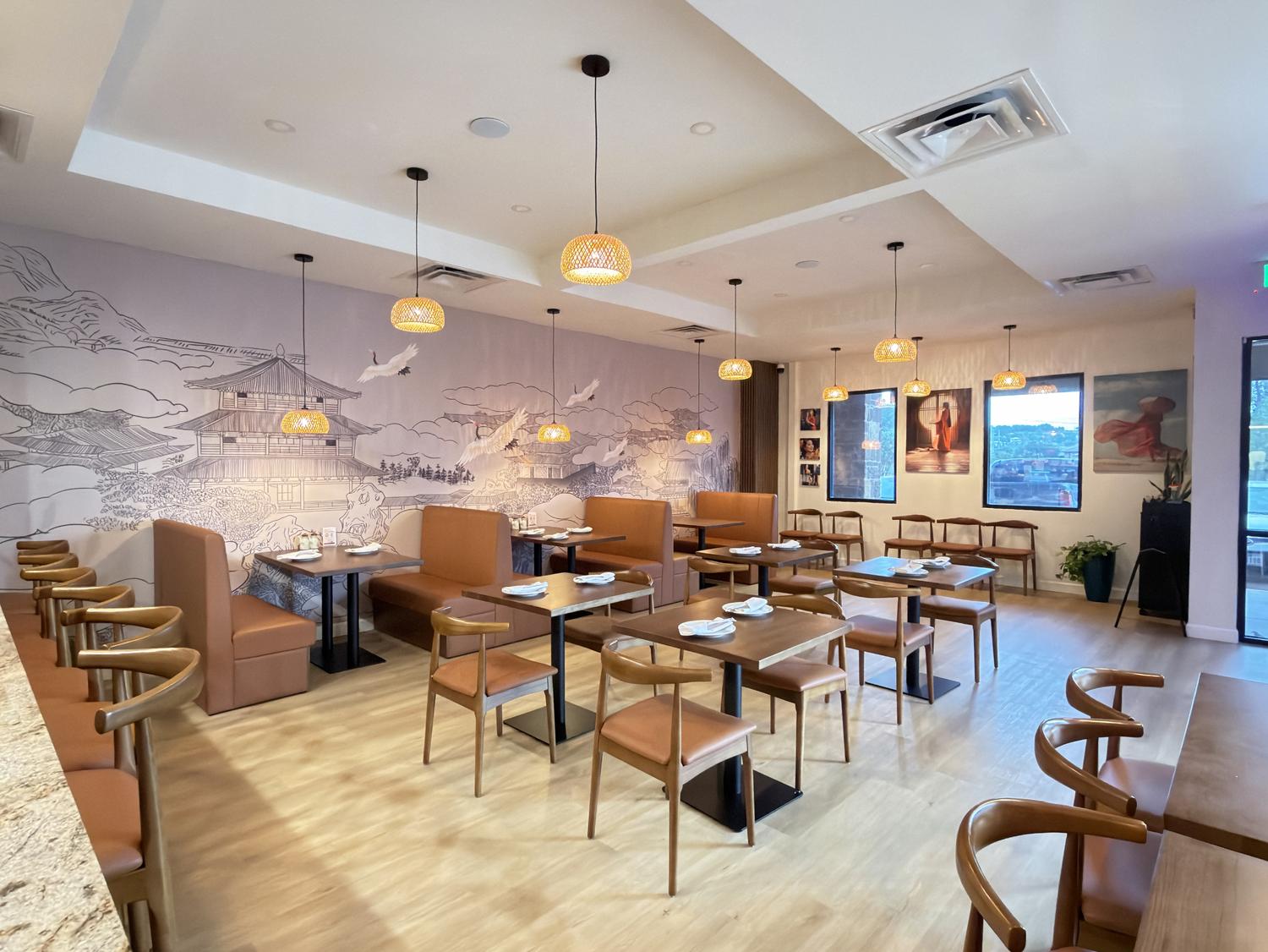 Spacious dining room with crane mural, booths, and pendant lights at SoHo Asian Fusion, a Asian fusion restaurant in Austin