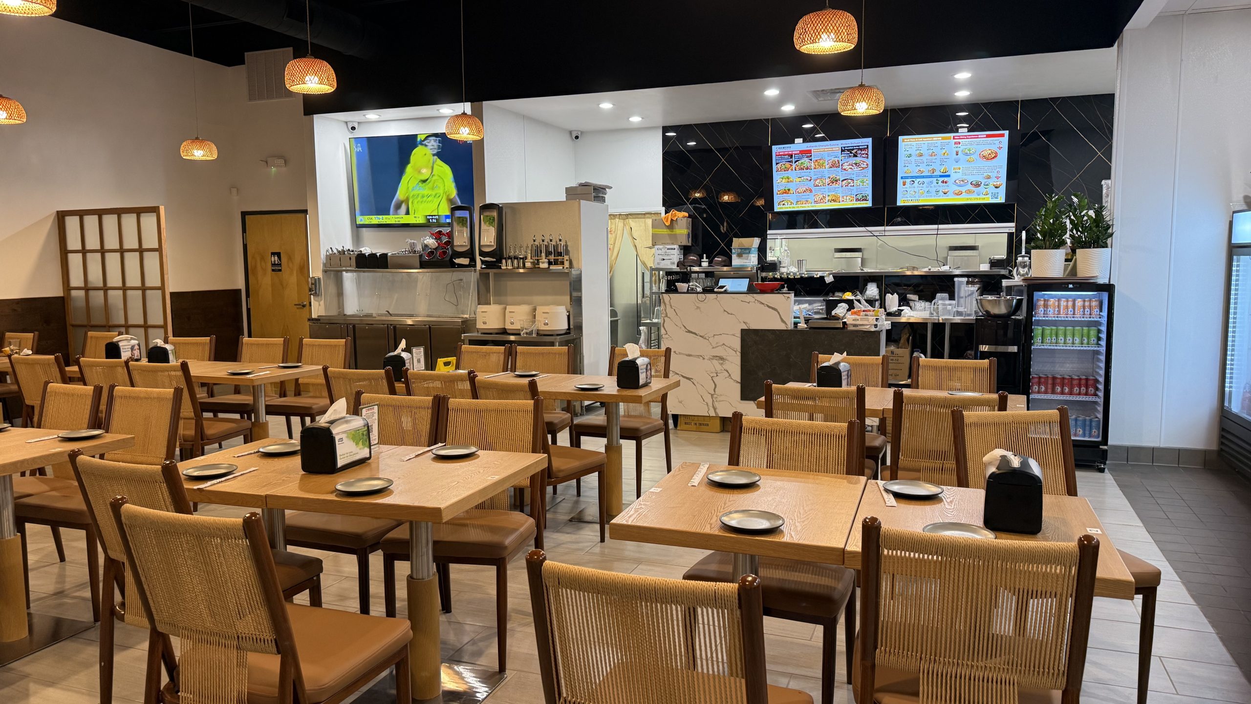 Spice House dining space with open kitchen and menu screens at Spice House, a Chinese Restaurant in Plano