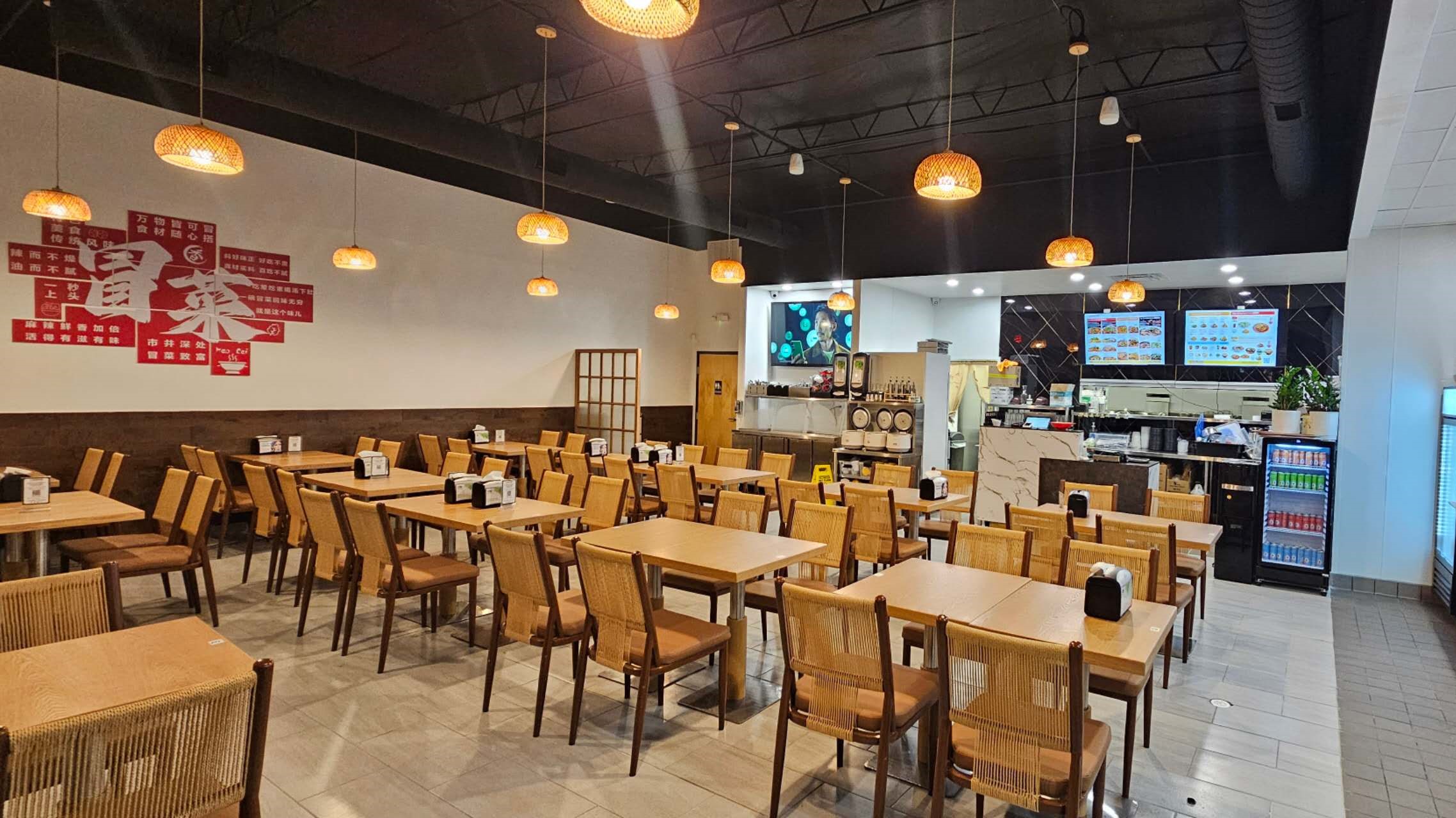 Bright Spice House dining room with rattan chairs and red murals at Spice House, a Chinese Restaurant in Plano