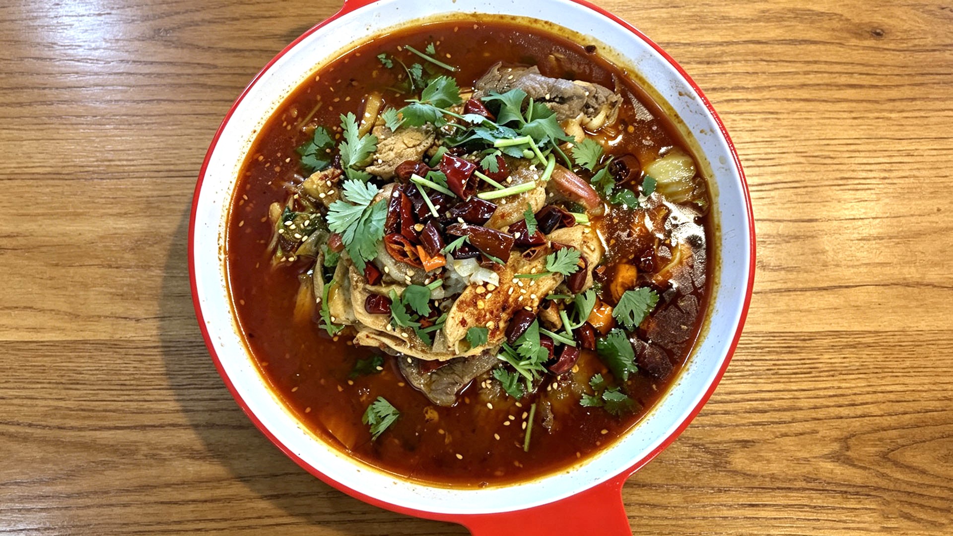 Spicy Sichuan-style boiled beef with chili oil and cilantro at Spice House, a Chinese Restaurant in Plano