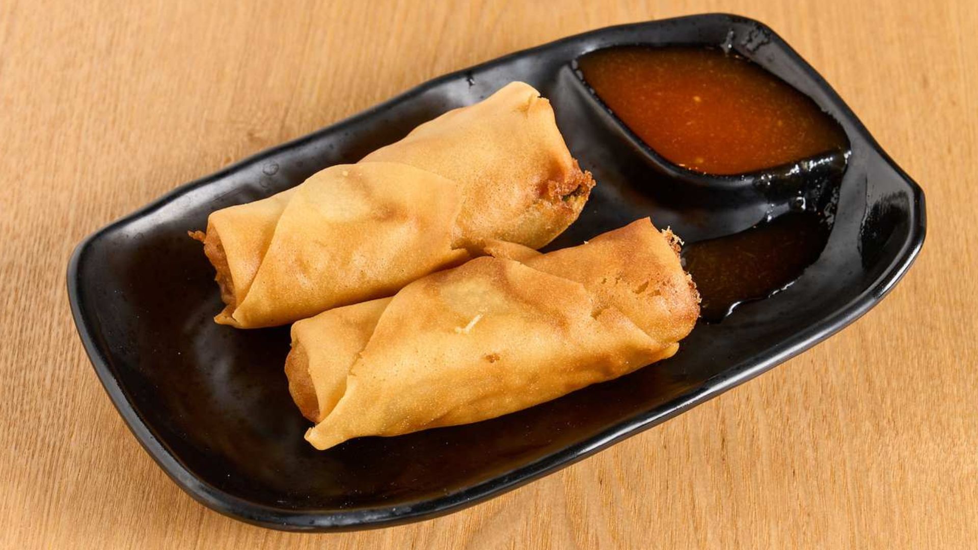 Crispy fried spring rolls with sweet chili dipping sauce at Spice House, a Chinese Restaurant in Plano