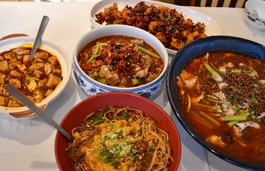 Spicy Sichuan dishes including mapo tofu and noodles at Spice Spirit JC, a Sichuan restaurant in Jersey