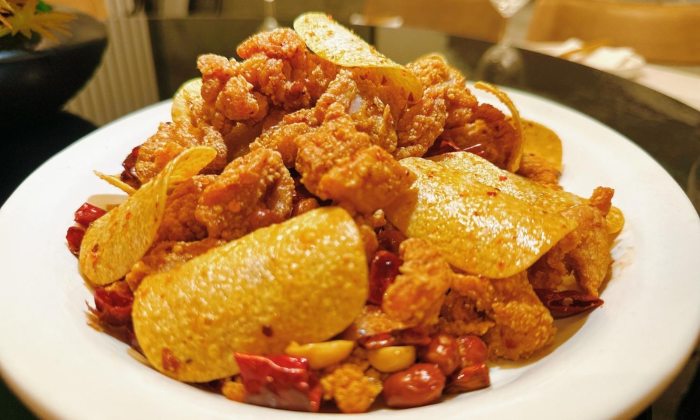 Crispy chicken mixed with potato chips, red chilies, and peanuts at Spicy Home 那家川菜，a Chinese Restaurant in Hacienda Heights