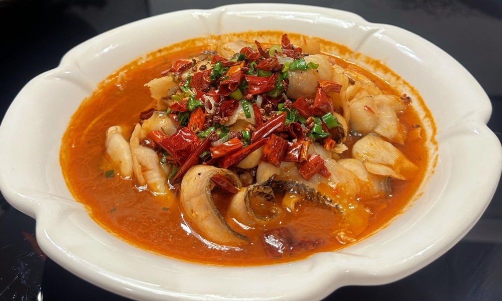 Flaky fish in spicy red broth topped with chili peppers and green onions at Spicy Home 那家川菜，a Chinese Restaurant in Hacienda Heights