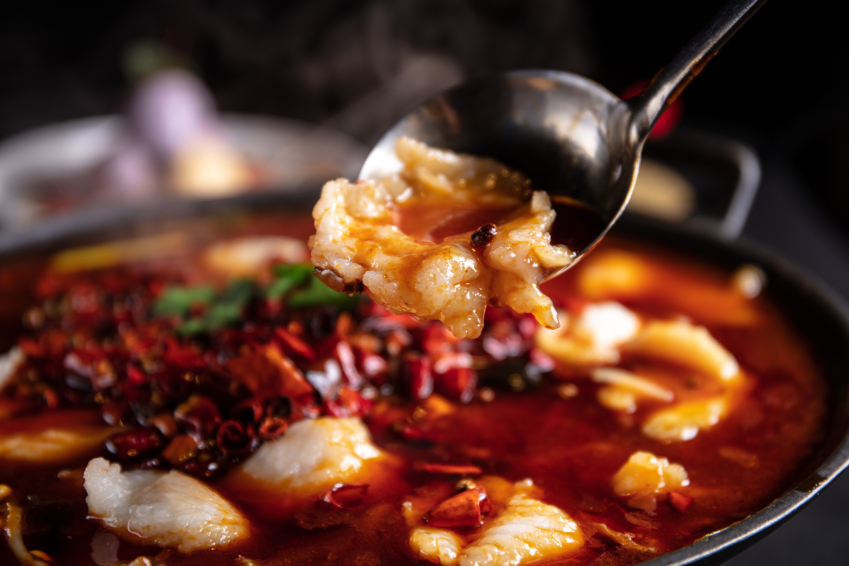Fish fillets in a spicy hot pot broth, topped with chili peppers and herbs at Spicy Hunan 湘菜小厨, a Chinese restaurant in Houston