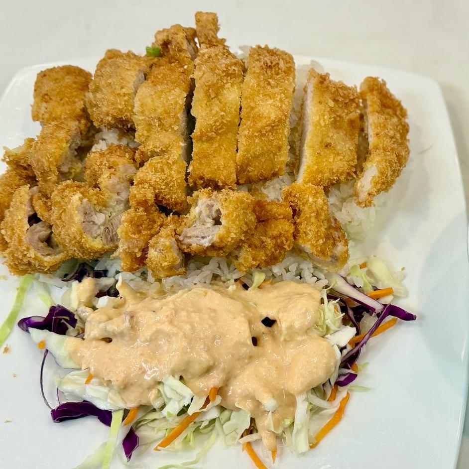 Breaded chicken katsu served over rice with creamy sauce and shredded cabbage at Starbelly Asian Kitchen, a Asian Fusion Restaurant in Montclair