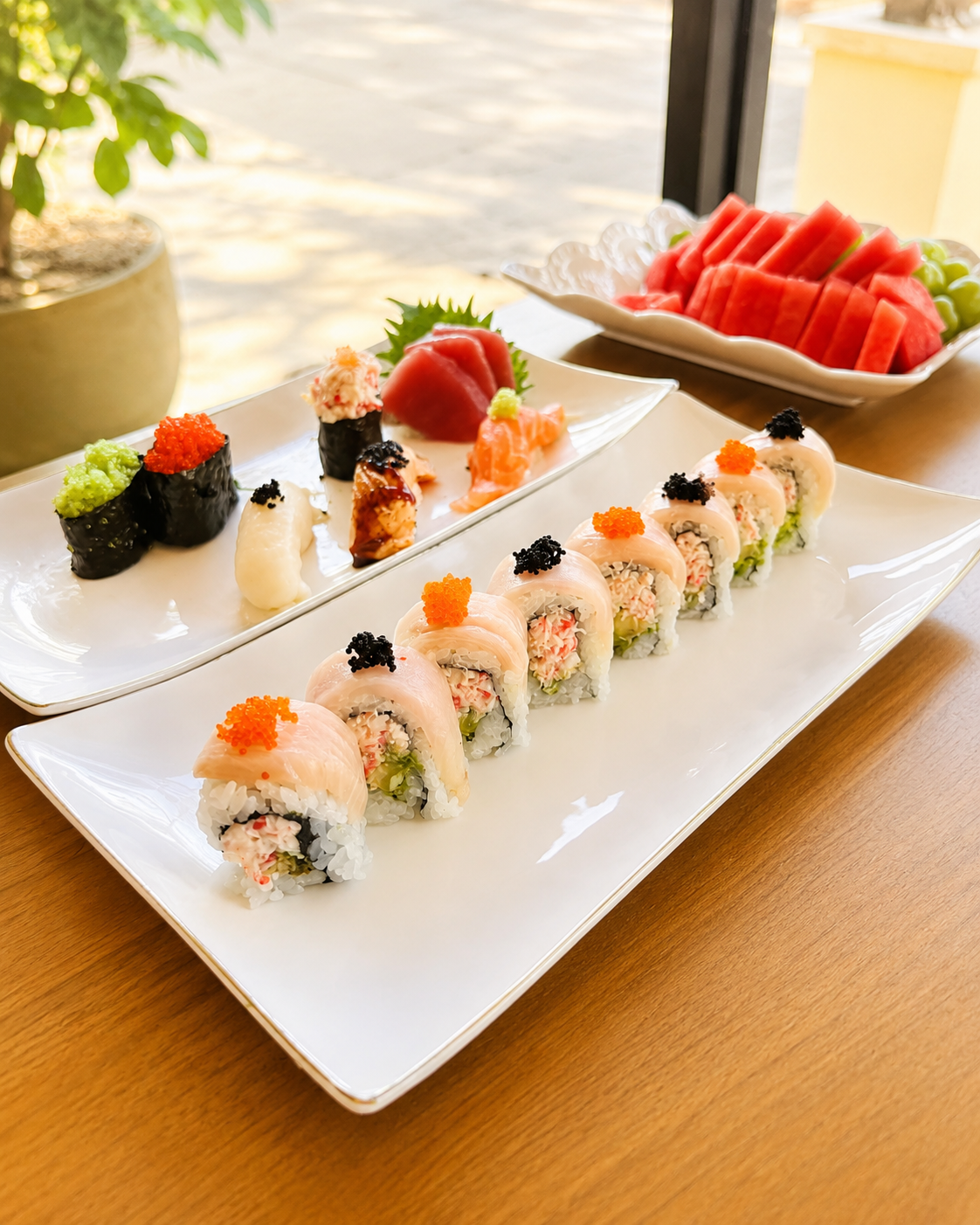 Assorted sushi rolls sashimi and fresh fruit at Sucré d’Amour Café & Sushi, a Sushi Restaurant in Fremont