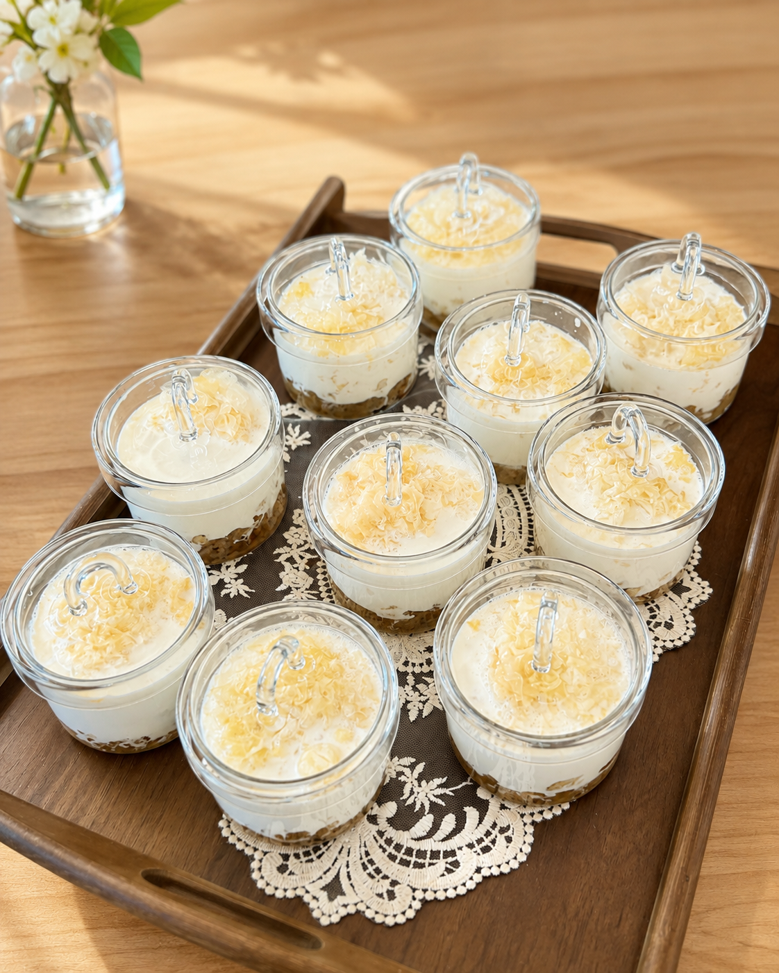 Nine creamy dessert cups on a wooden tray at Sucré d’Amour Café & Sushi, a Sushi Restaurant in Fremont