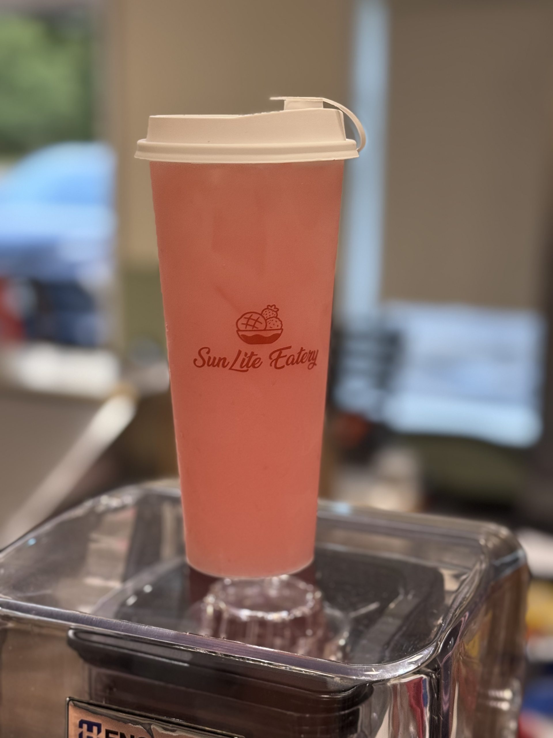 Pink fruity iced drink in branded SunLite Eatery plastic cup at SunLite Eatery，an Asian Fusion Restaurant in Rochester