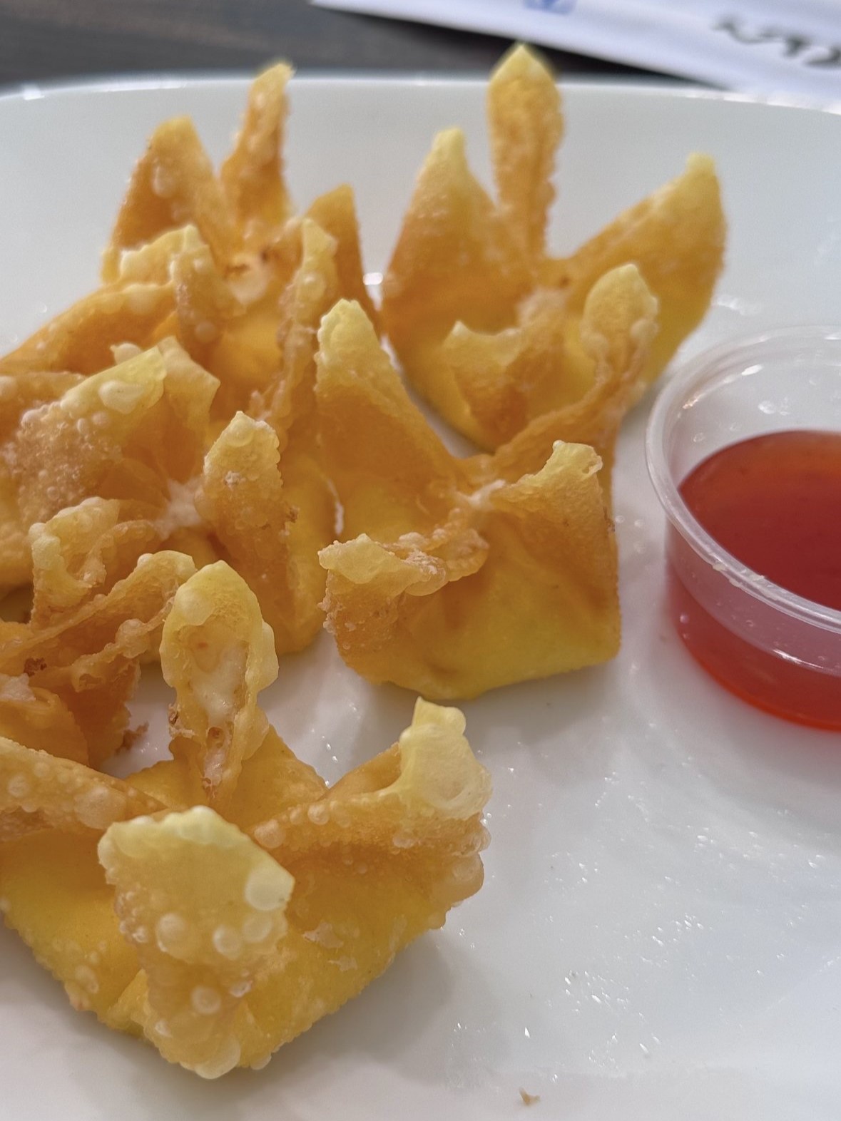 Golden fried cheese wontons served with sweet red dipping sauce at SunLite Eatery，an Asian Fusion Restaurant in Rochester