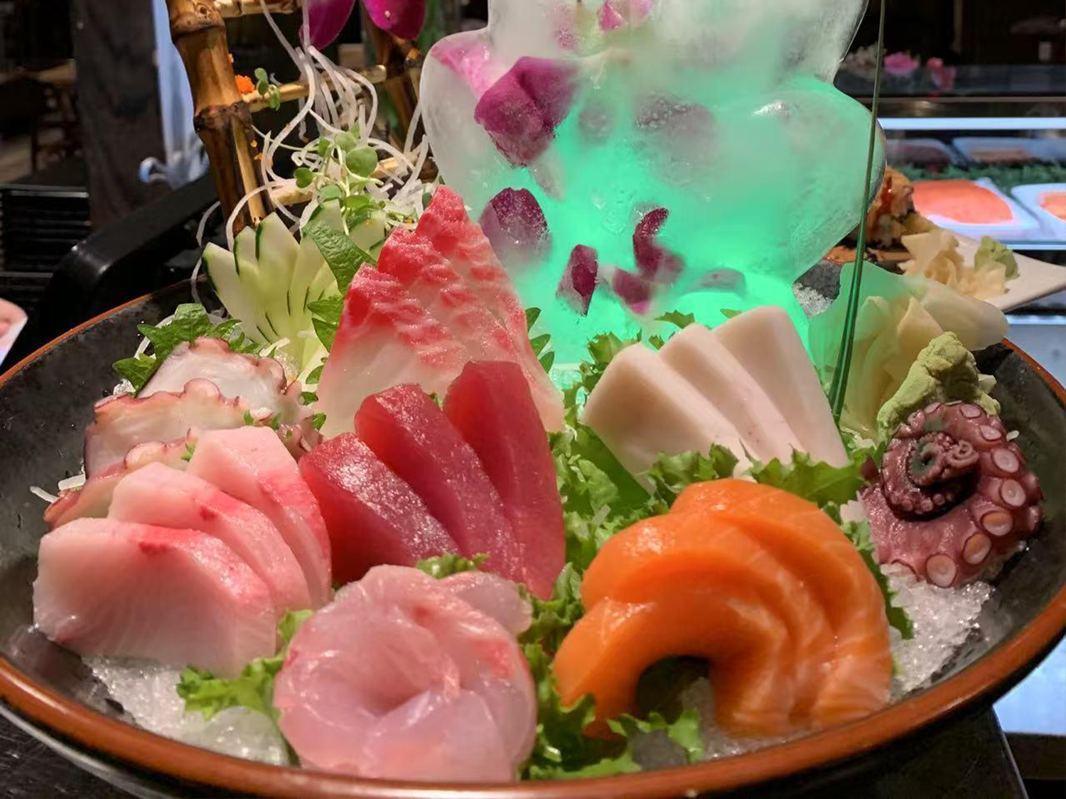 Sashimi platter with seafood and ice sculpture from Sushi & Asian Kitchen, a sushi restaurant in Weatfield