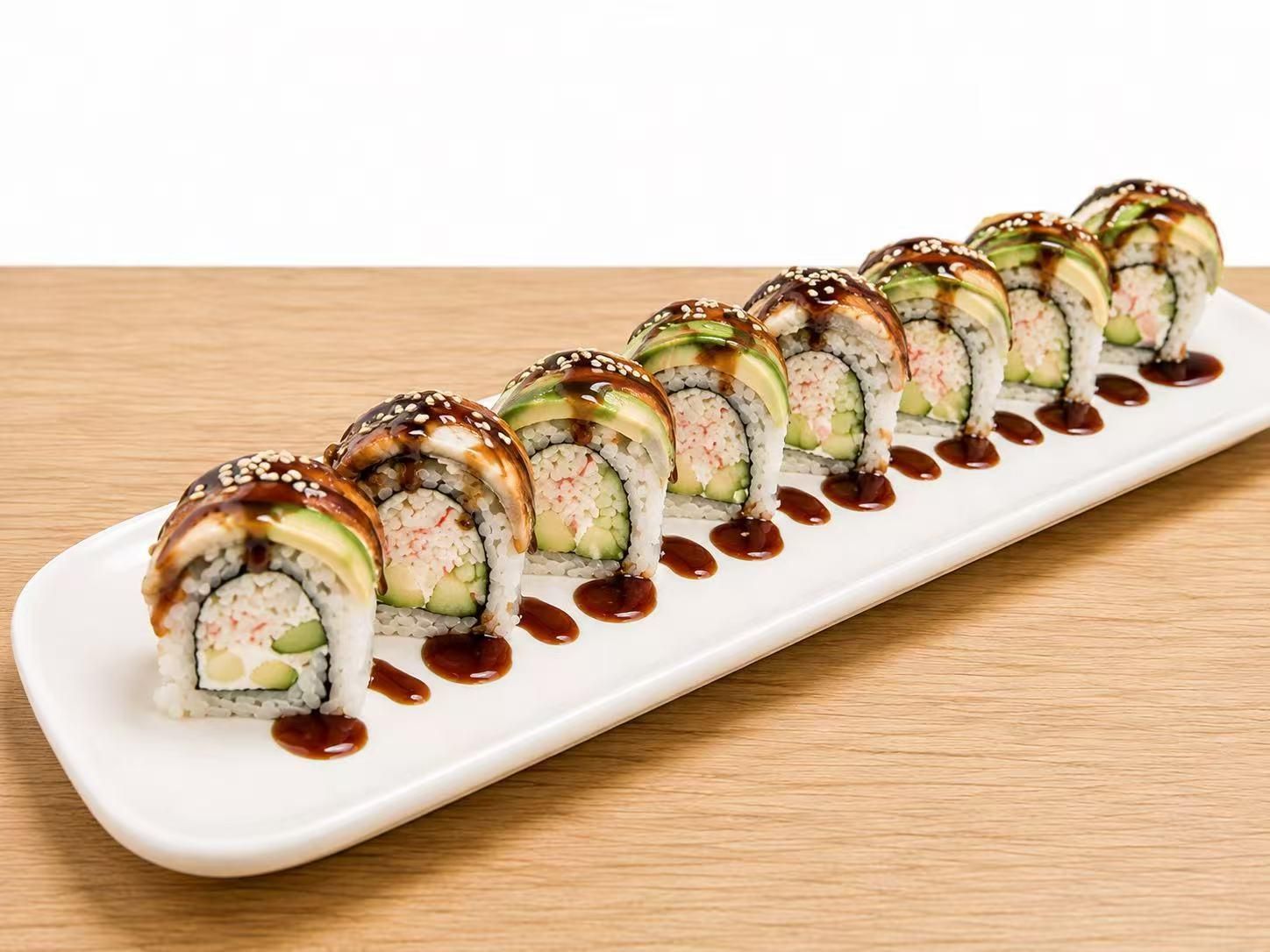 Eight pieces of eel avocado sushi roll on a white rectangular plate with teriyaki sauce