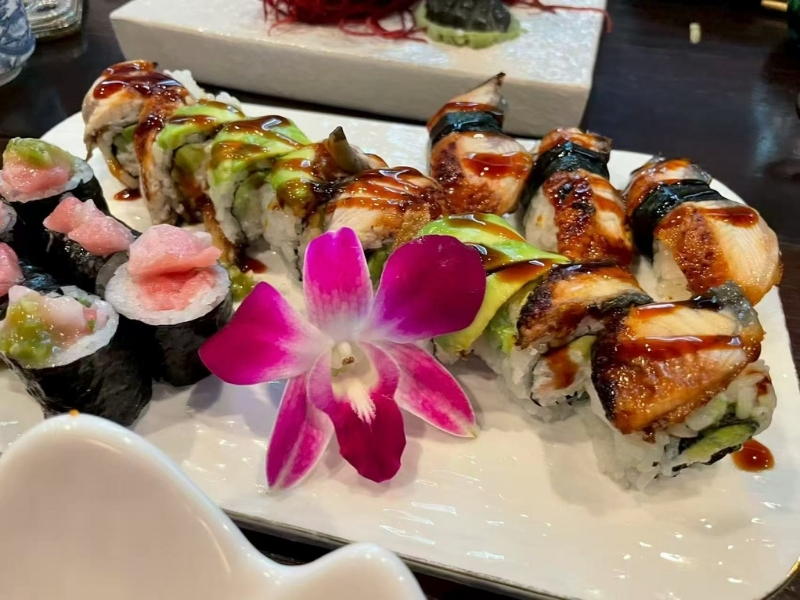 Sushi-King-&-Grill-Japanese-Restaurant-Sushi-Platter-Corona A platter of assorted sushi with a decorative flower at Sushi King & Grill, a Japanese Restaurant in Corona.