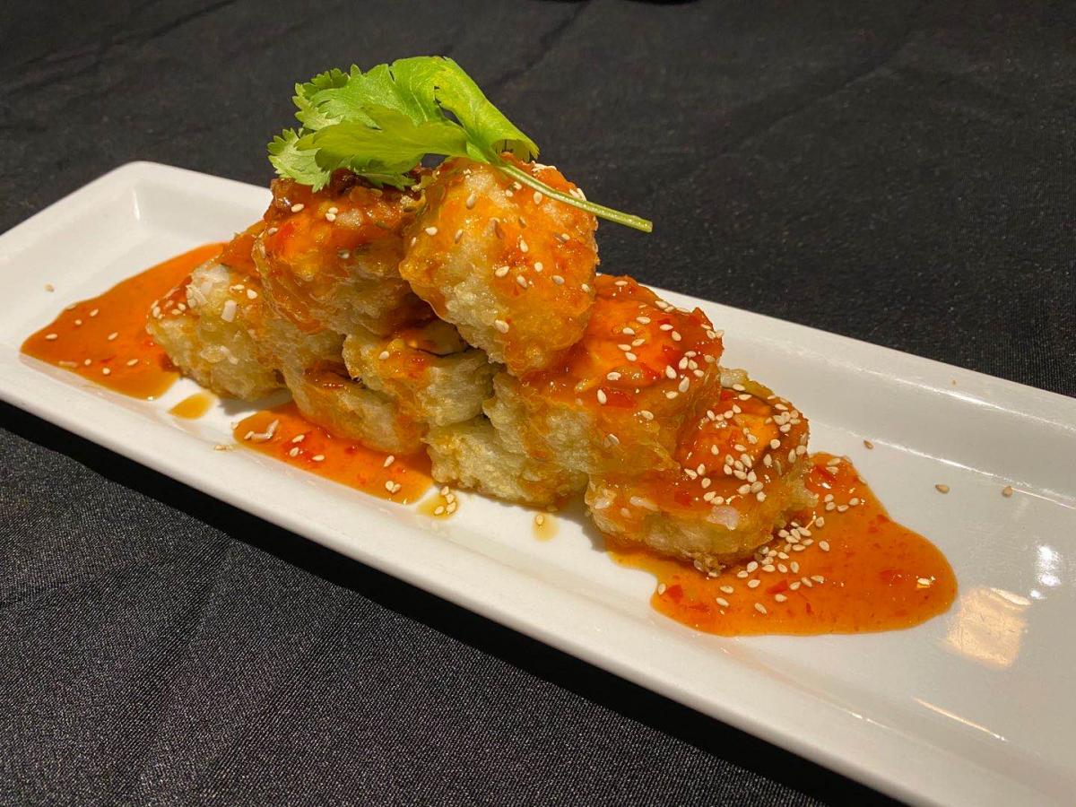 Crispy fried tofu with sweet chili sauce and sesame seeds