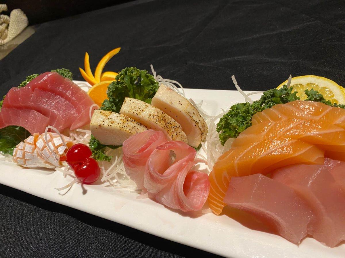 Assorted sashimi platter with tuna, salmon, lemon and garnishes