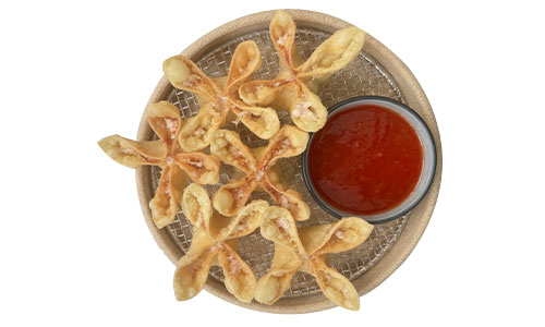 Overhead shot of flower-shaped crispy fried cheese wontons on mesh plate, small bowl of red sweet sauce, white background.