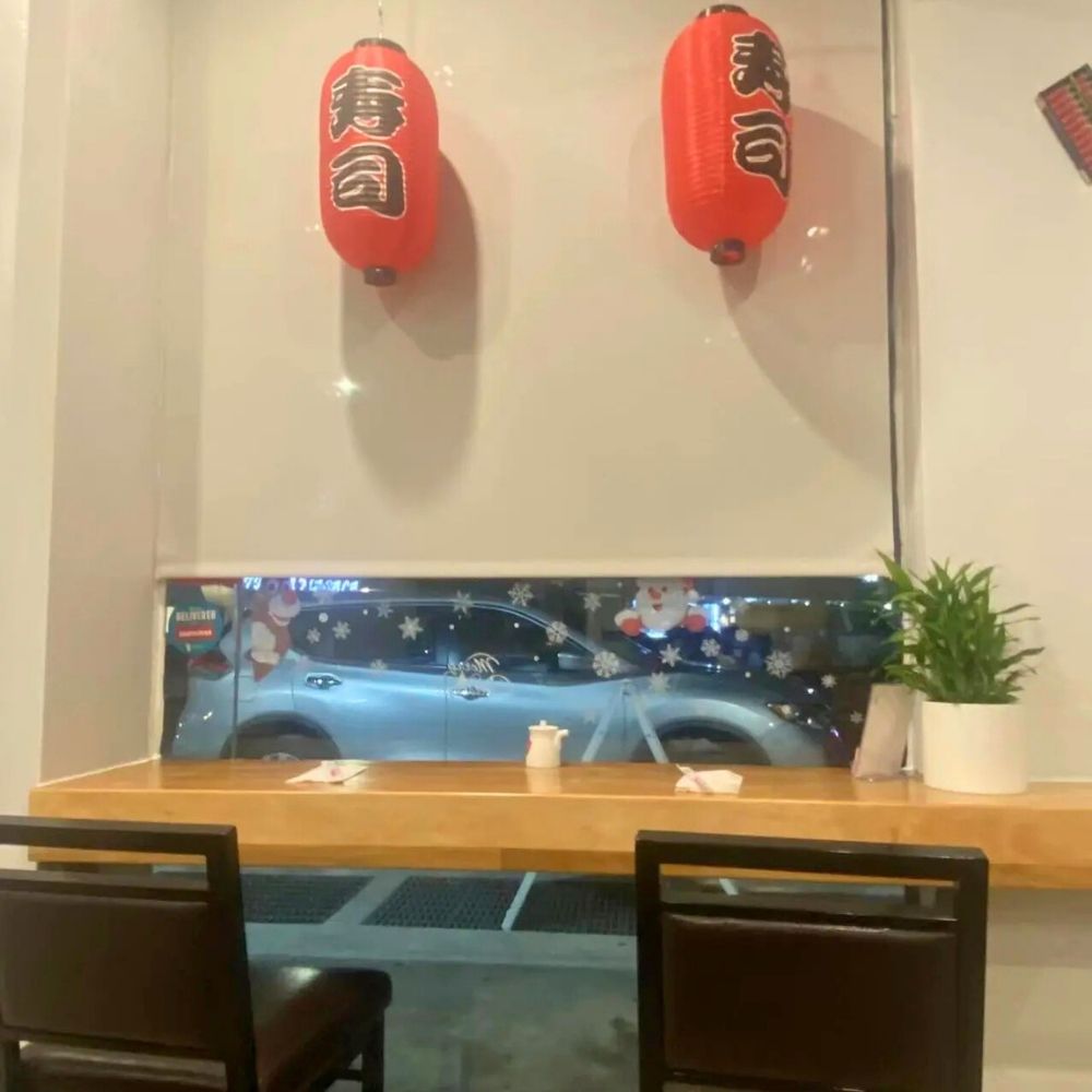 Cozy dining area with red lanterns and wooden tables at Sushi of Miso, a Japanese Restaurant in Long Island City.