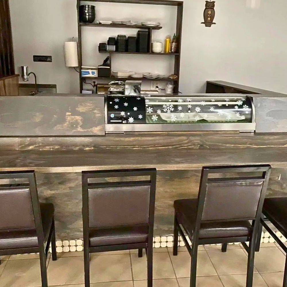 Modern sushi bar with seating and refrigerated display case at Sushi of Miso, a Japanese Restaurant in Long Island City.