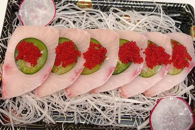 A sashimi platter with slices of raw fish, served on shredded white radish at SUSHI YA，a Japanese Restaurant in Philadelphia