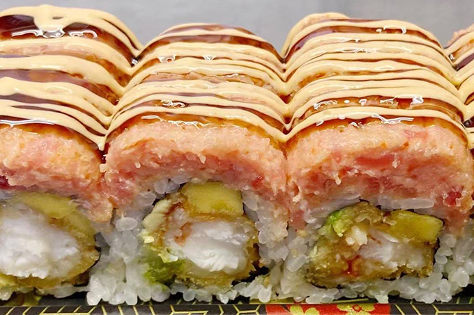 Sushi rolls with a sauce drizzled over them at SUSHI YA，a Japanese Restaurant in Philadelphia