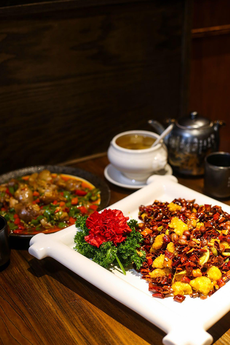 Spicy dishes with soup, decorated with a flower at Szechuan Gourmet, a Chinese restaurant in New York