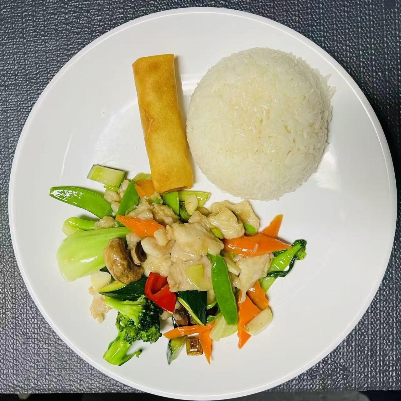 Lunch combo with chicken, veggies, rice and egg roll at Szechuan Impression, a Chinese Restaurant in Federal Way