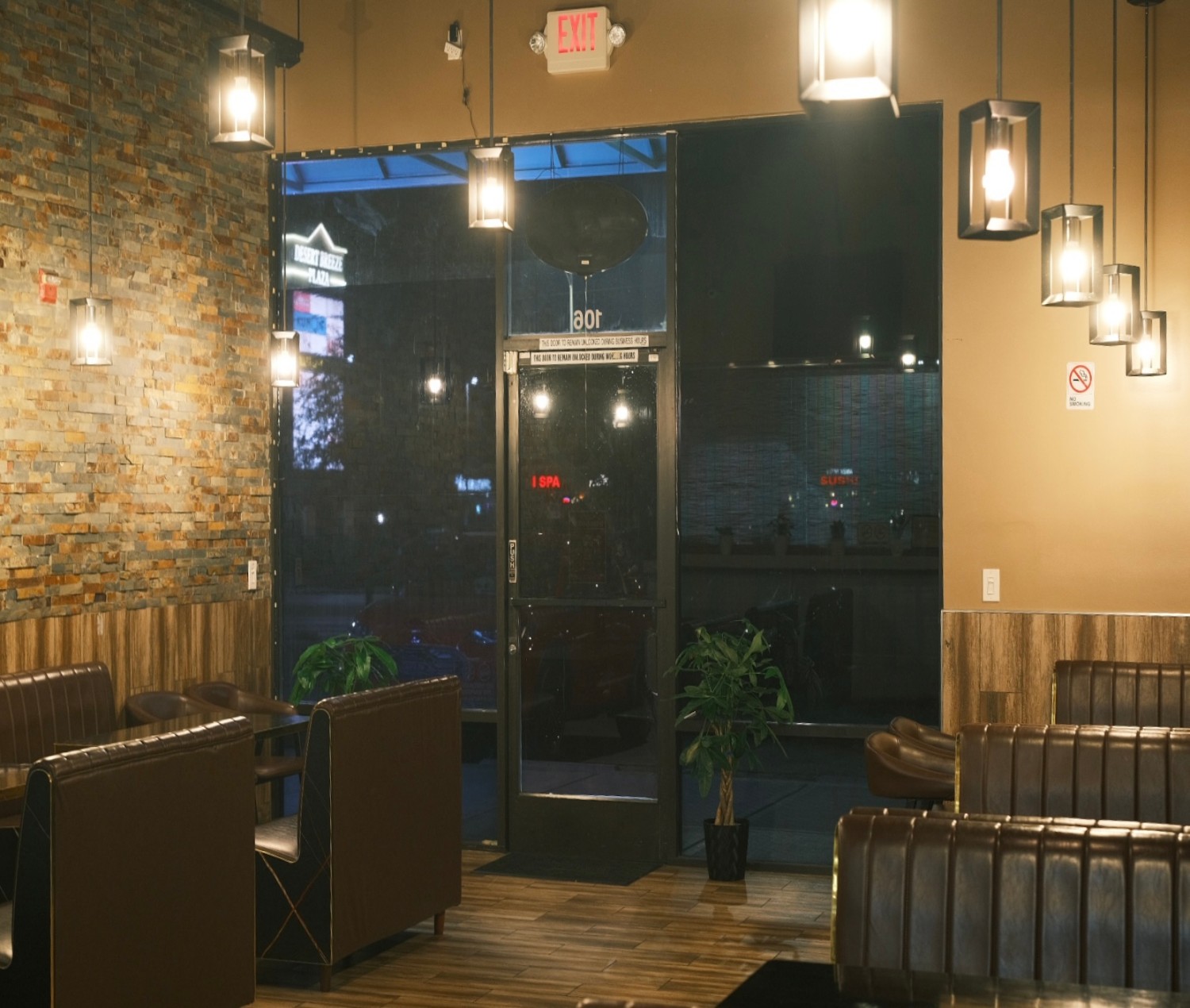 Szechuan-Kitchen-Chinese-Restaurant-Entrance-Area-Las-Vegas Warm - lit space with stone wall, plants and exit sign.