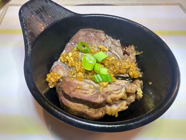 Braised Beef Shank - Tender beef shank braised to perfection, topped with garlic and scallions at T-Pot & BBQ, a Asian Fusion Restaurant in College Park