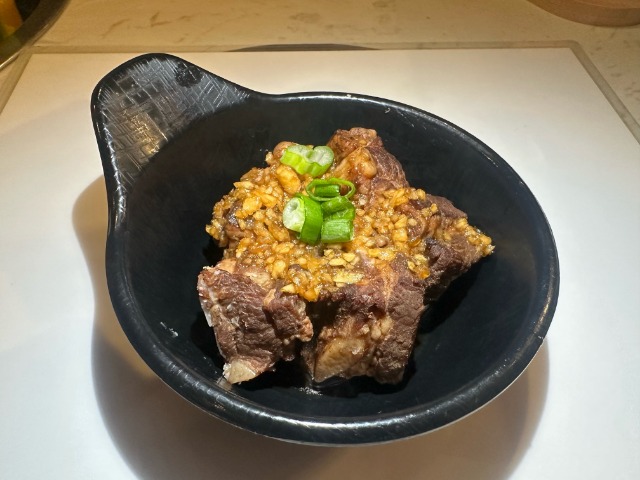 Braised Spare Ribs - Tender braised spare ribs with garlic and scallion garnish at T-Pot & BBQ, a Asian Fusion Restaurant in College Park