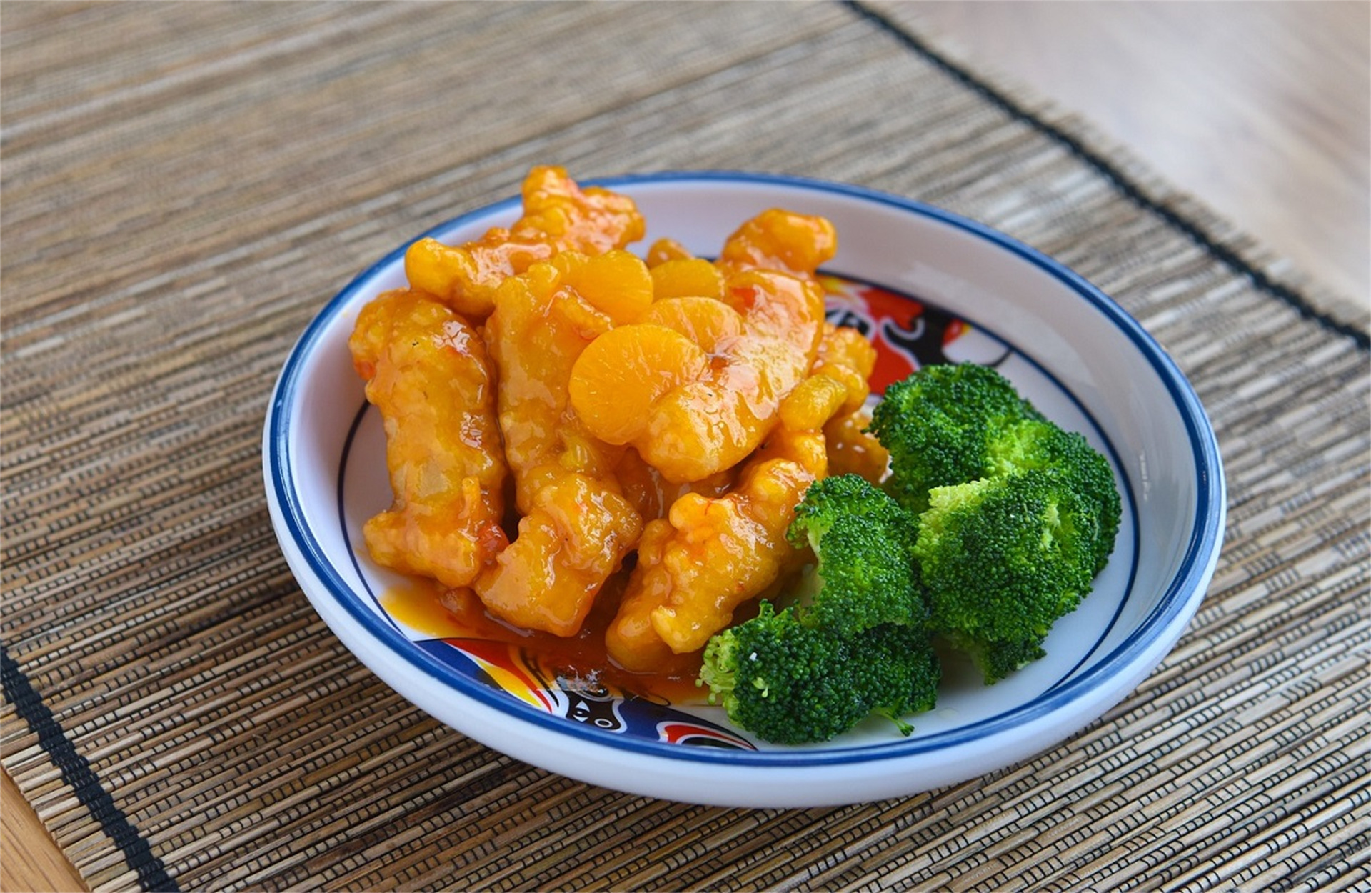 Citrus - glazed chicken, served with broccoli.