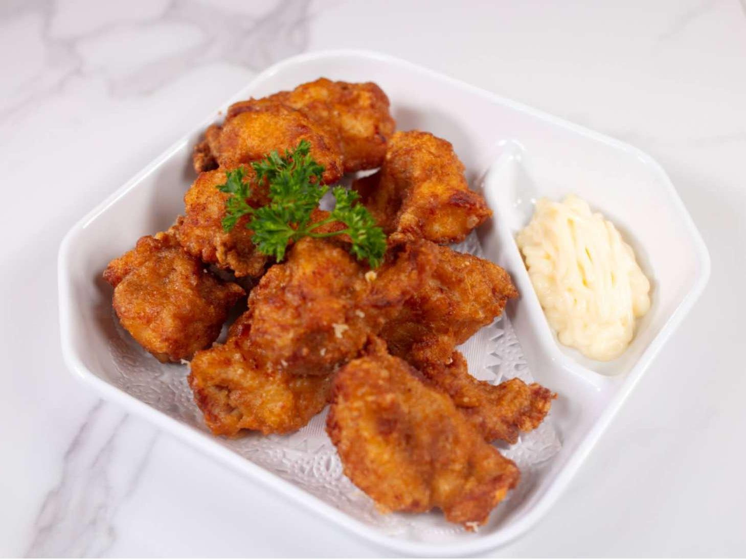 Crispy fried chicken bites served with creamy dipping sauce at Taki Sushi, a Japanese Restaurant in Toronto