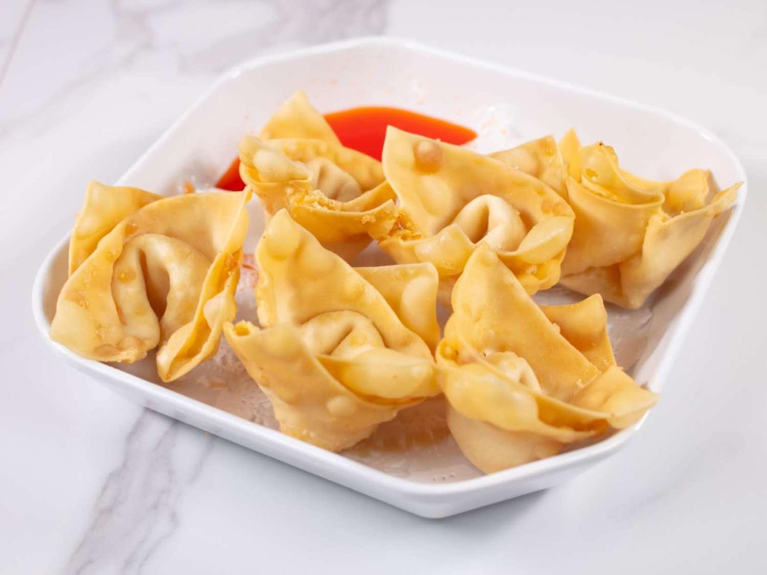 Crispy fried wontons served with spicy dipping sauce at Taki Sushi, a Japanese Restaurant in Toronto