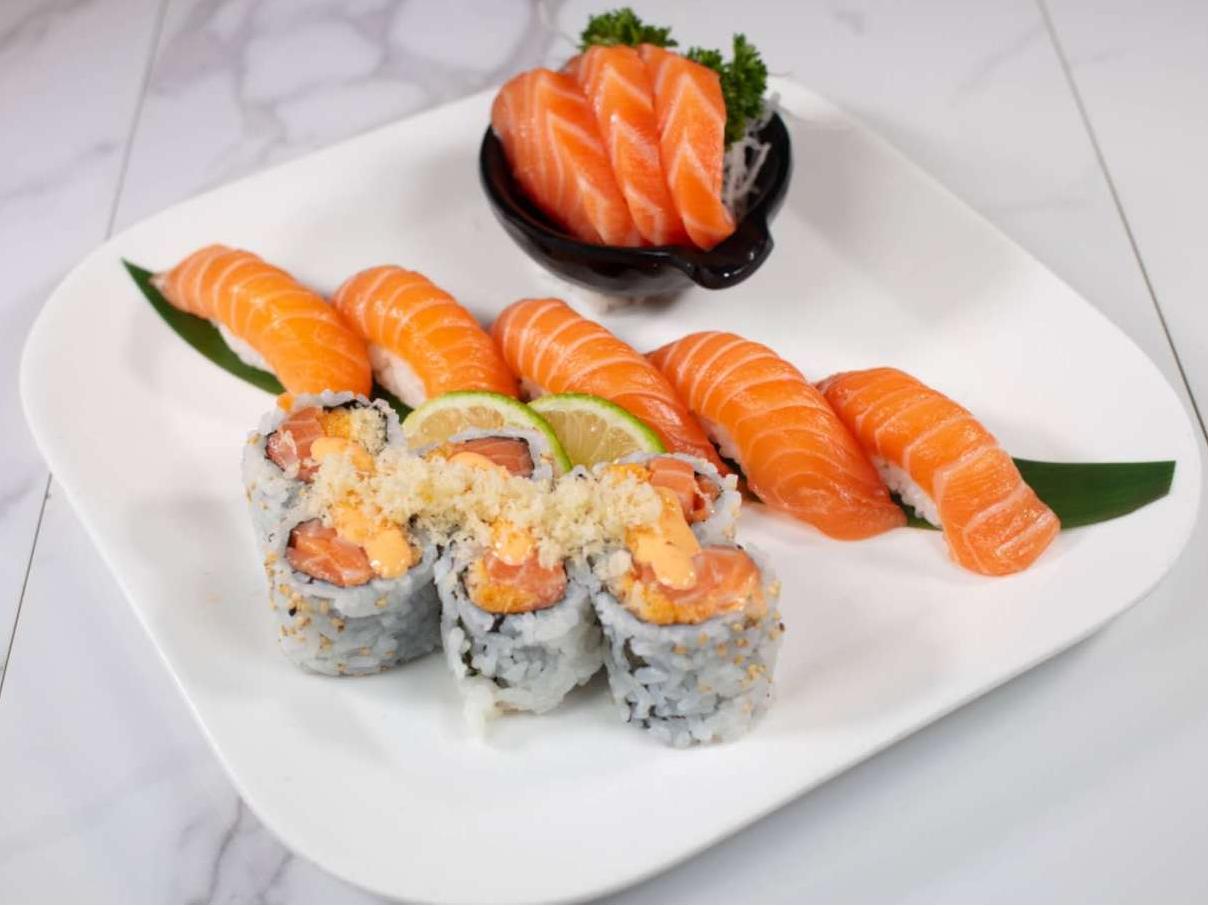 Salmon sashimi, nigiri & roll with sauce, served with lime at Taki Sushi, a Japanese Restaurant in Toronto