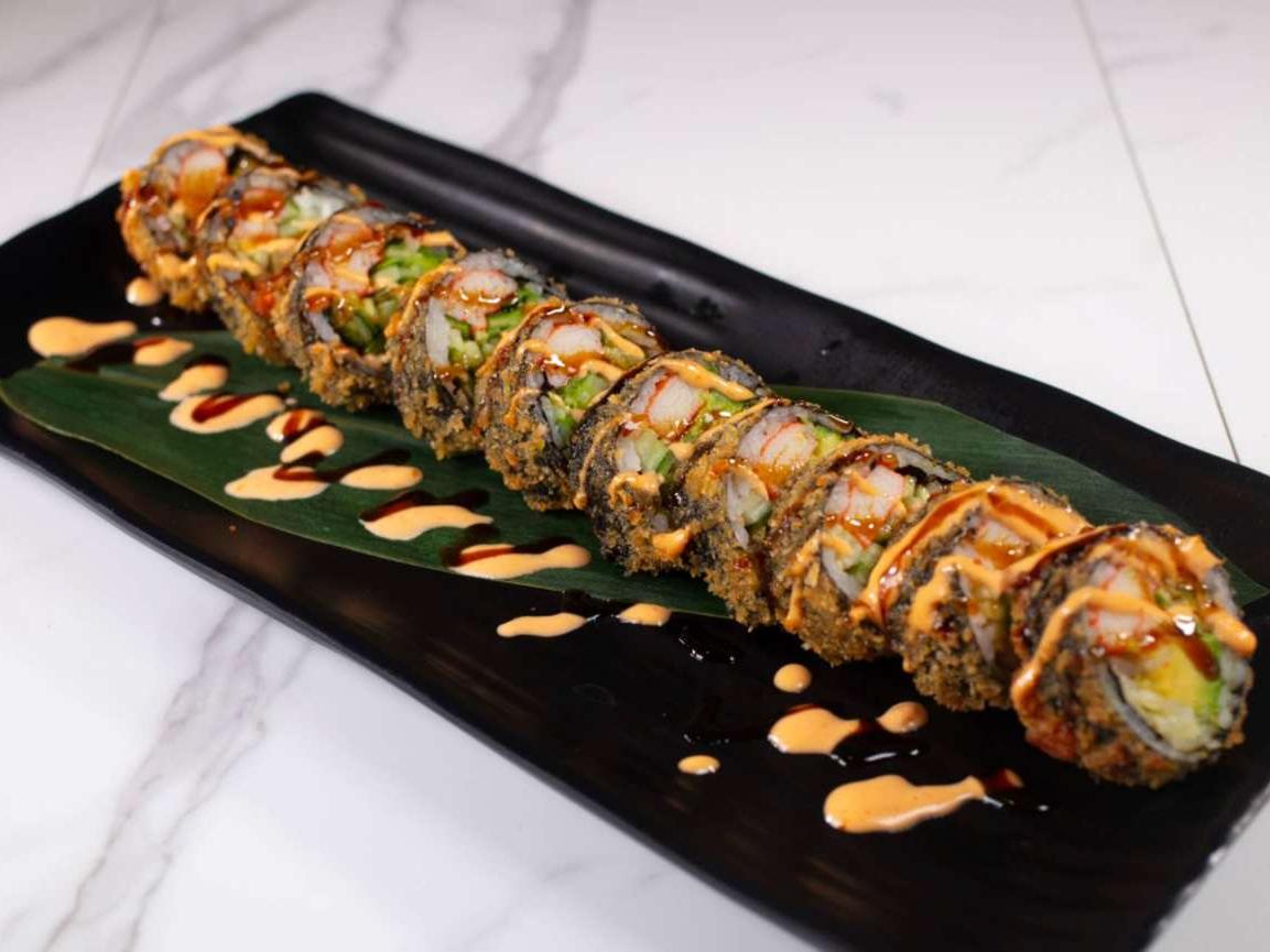Crispy-coated sushi roll with shrimp & veggies, drizzled with sauces at Taki Sushi, a Japanese Restaurant in Toronto