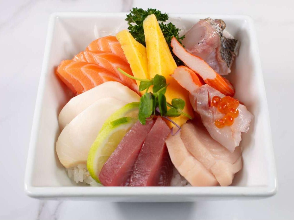 Assorted fresh sashimi over steamed rice, with mango & caviar at Taki Sushi, a Japanese Restaurant in Toronto