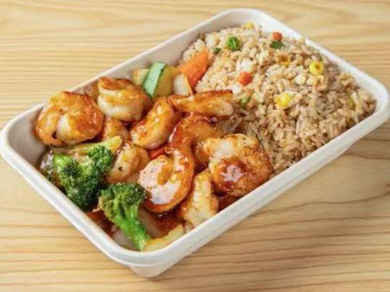 White disposable lunch tray with glazed teriyaki shrimp stir fry and mixed vegetable fried rice at Takuma Hibachi , a Japanese Restaurant in Hillsboro