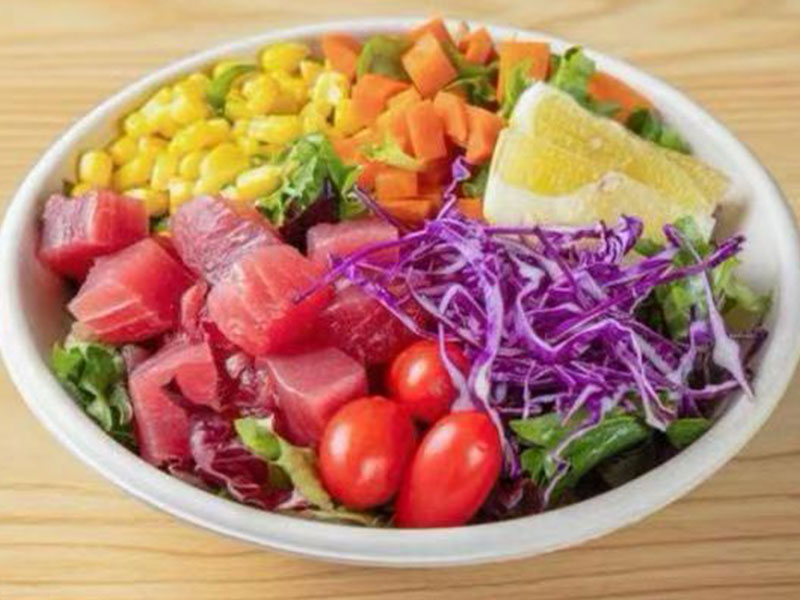 White ceramic poke bowl with fresh tuna cubes, purple cabbage, corn, cherry tomatoes and lemon wedge at Takuma Hibachi , a Japanese Restaurant in Hillsboro