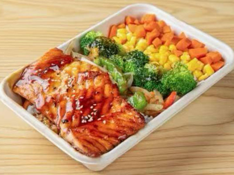 Takeout lunch tray with teriyaki glazed salmon fillet, broccoli, diced carrot and sweet corn medley at Takuma Hibachi , a Japanese Restaurant in Hillsboro