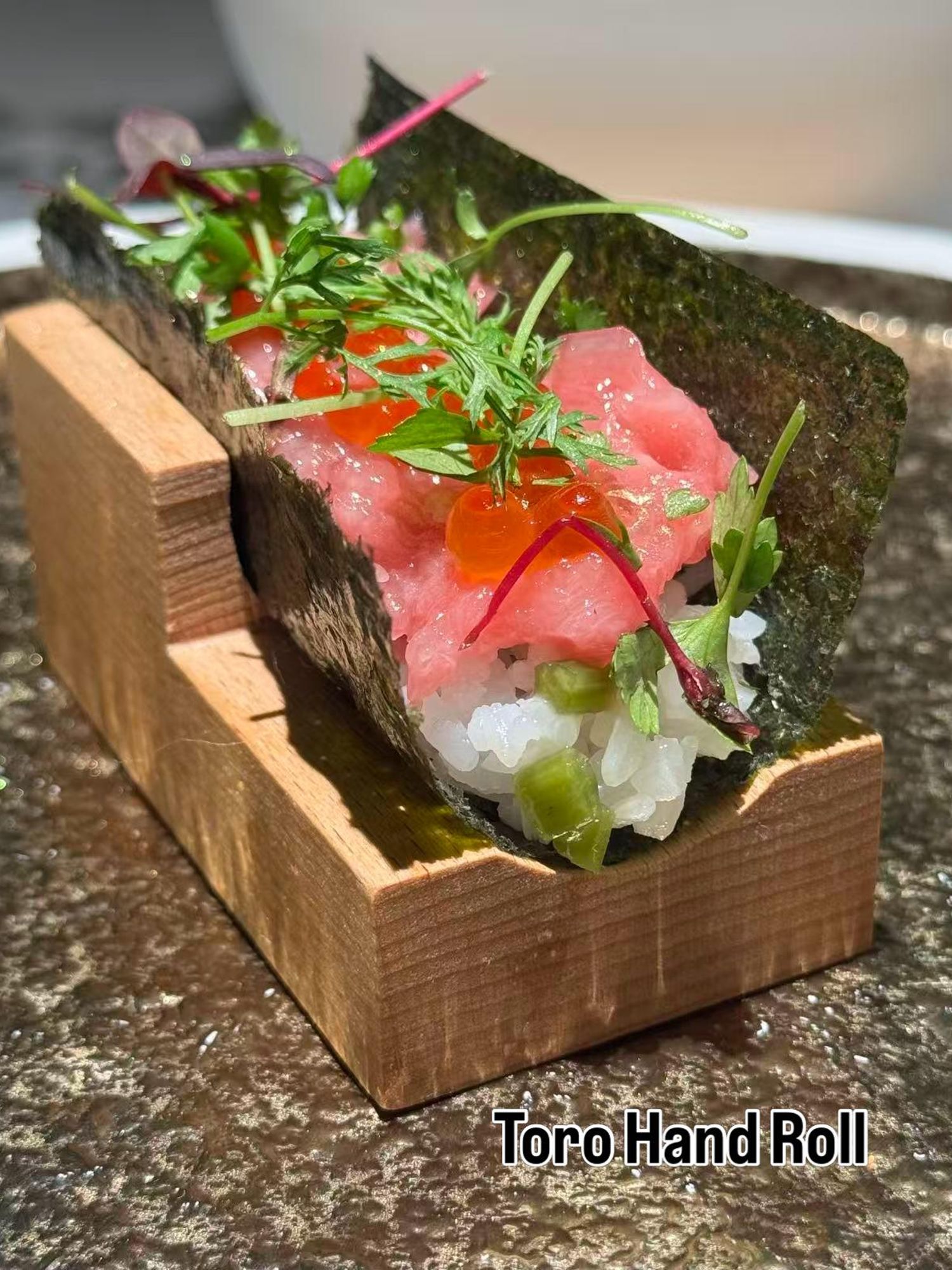 Toro tuna hand roll with ikura at Takumi Sushi A.Y.C.E, a Japanese Restaurant in Columbus