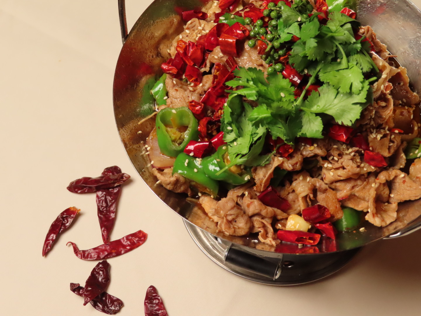 Hot pot beef slices with chilies and cilantro at Tang Pavilion, a Chinese Restaurant in New York
