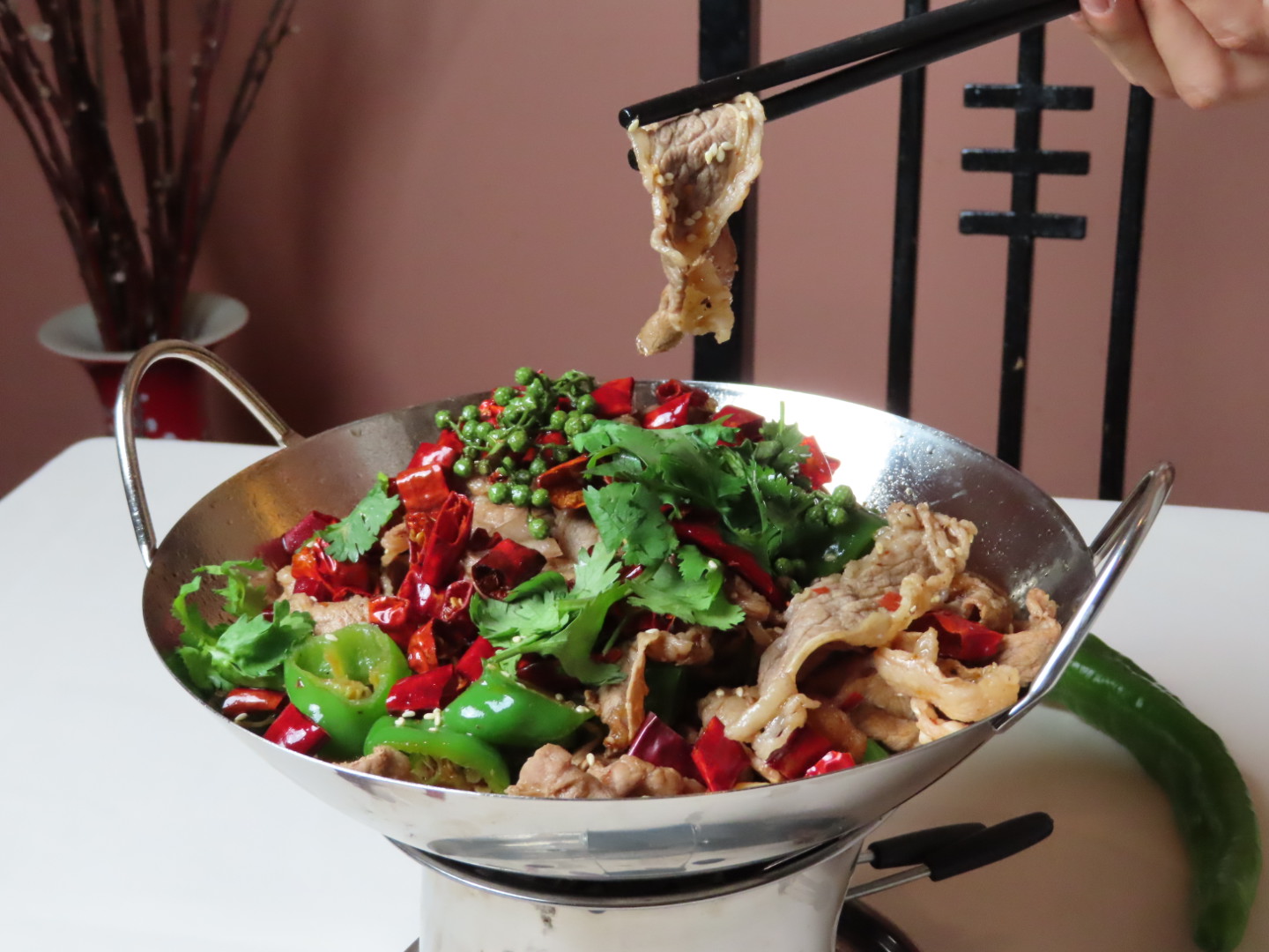 Hot pot pork slices with chilies and cilantro at Tang Pavilion, a Chinese Restaurant in New York