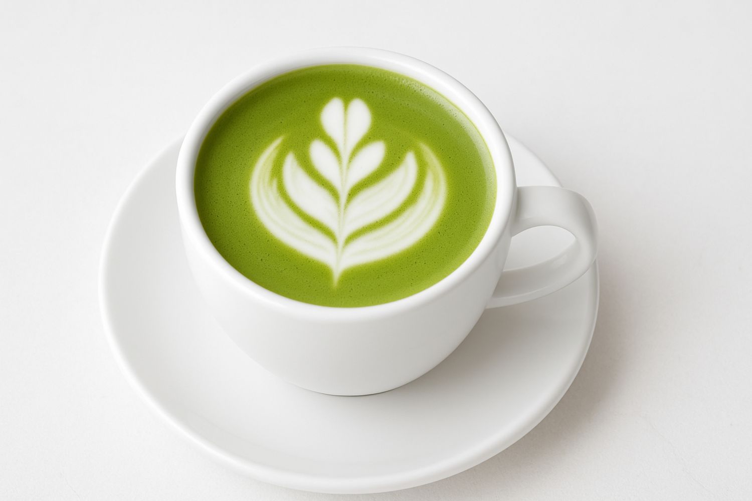 Artfully latte art matcha latte in a white ceramic cup at Tangscape, a Cafe in Forest Hills