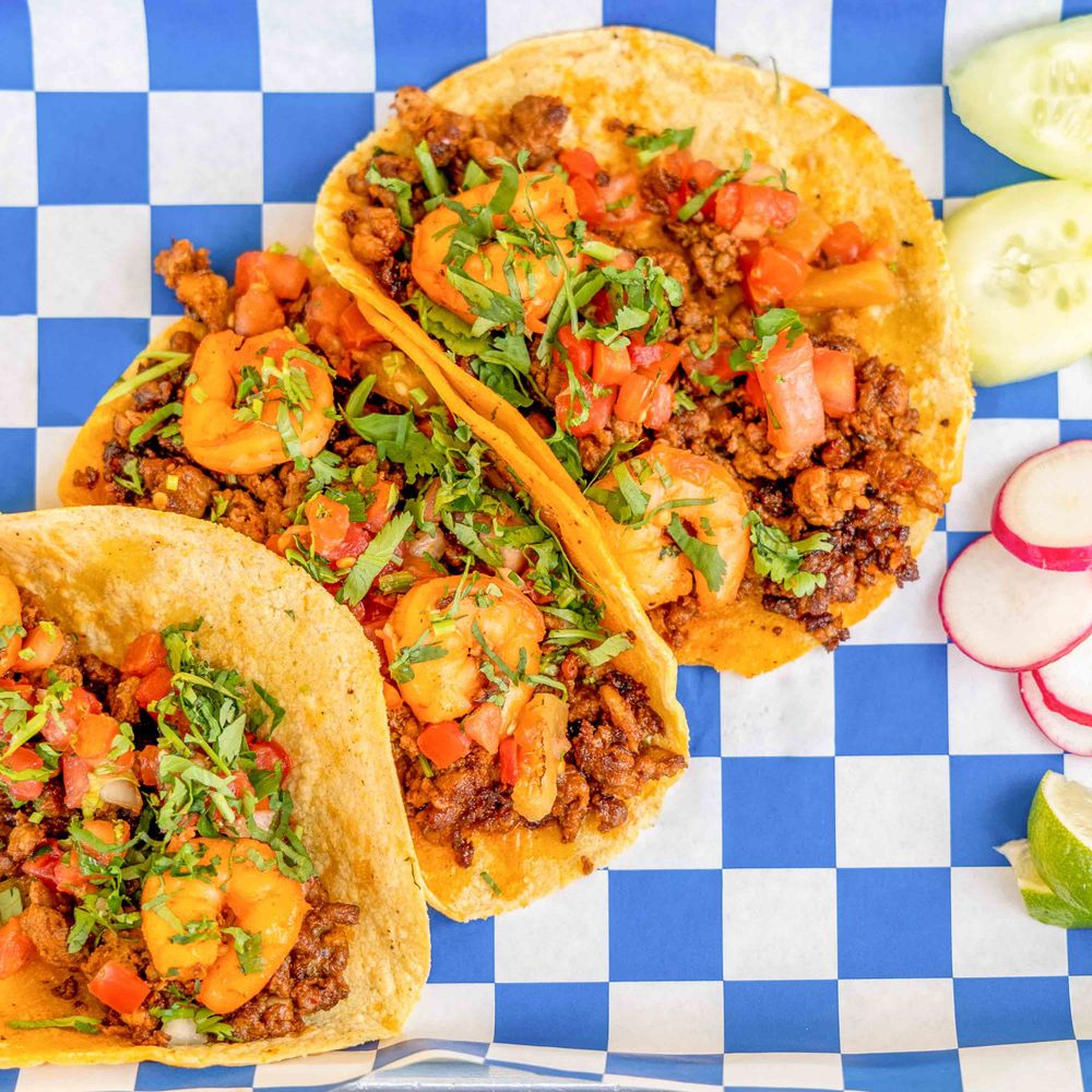 Chorizo and shrimp tacos topped with pico de gallo and fresh cilantro Chorizo and shrimp tacos topped with pico de gallo and fresh cilantro