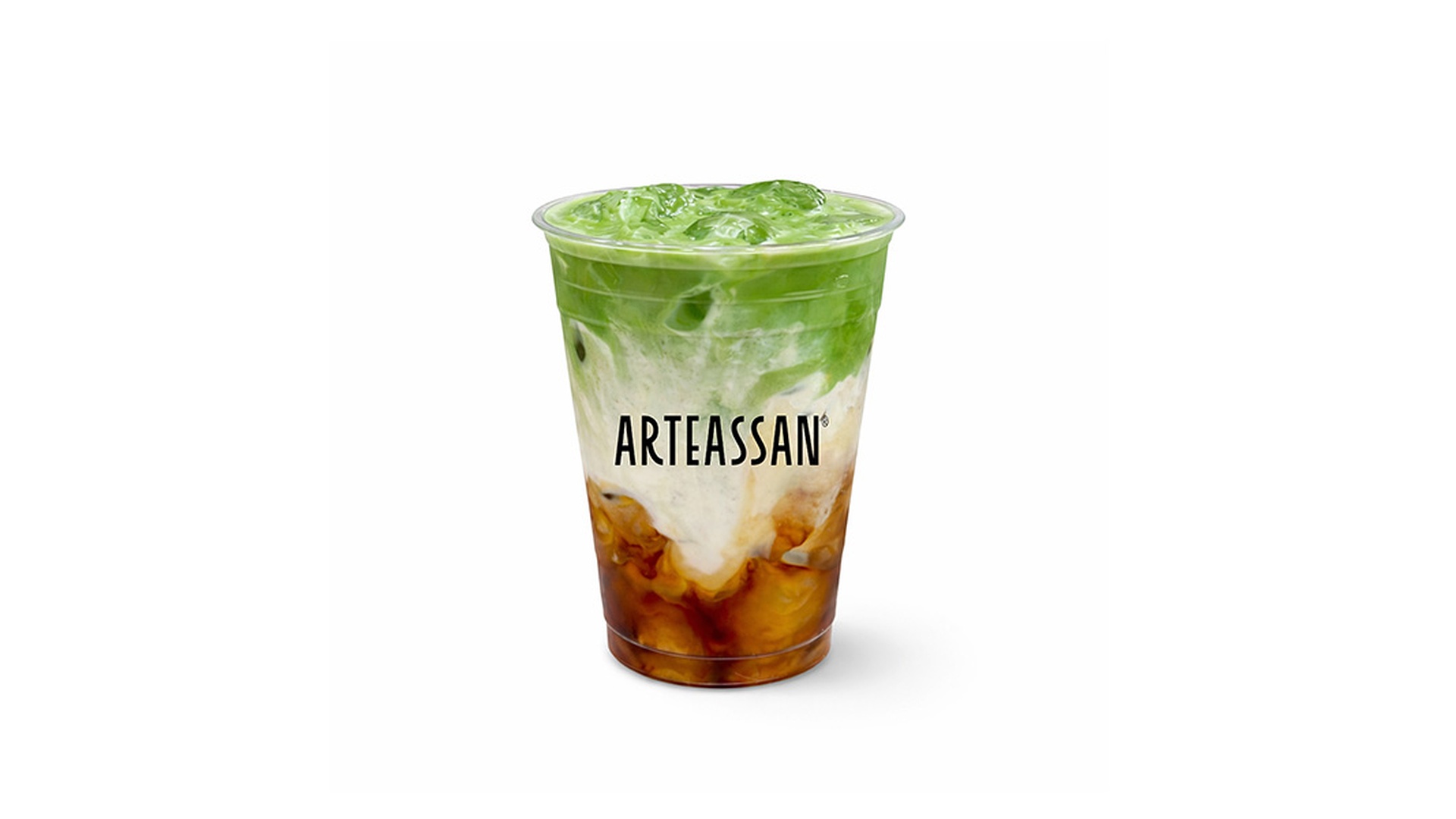 A layered iced beverage in a clear cup with the brand name "ARTEASSAN" printed on it, showing distinct layers of dark amber brown sugar syrup at the bottom, white milk in the middle, and bright green matcha tea on top at Tart Tart Bakery, a Cake shop in Hicksville