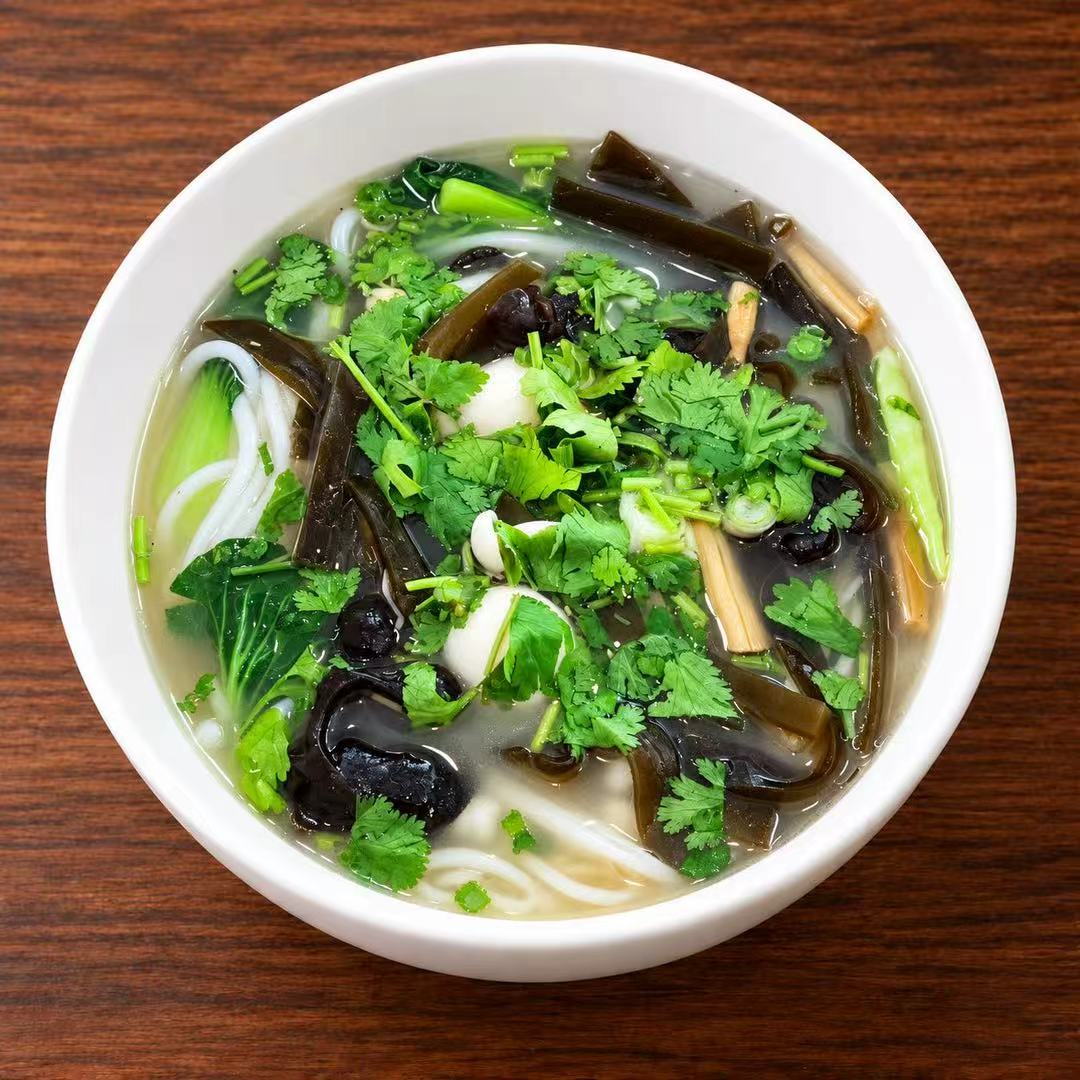 Clear broth rice noodles with kelp, fungus and cilantro