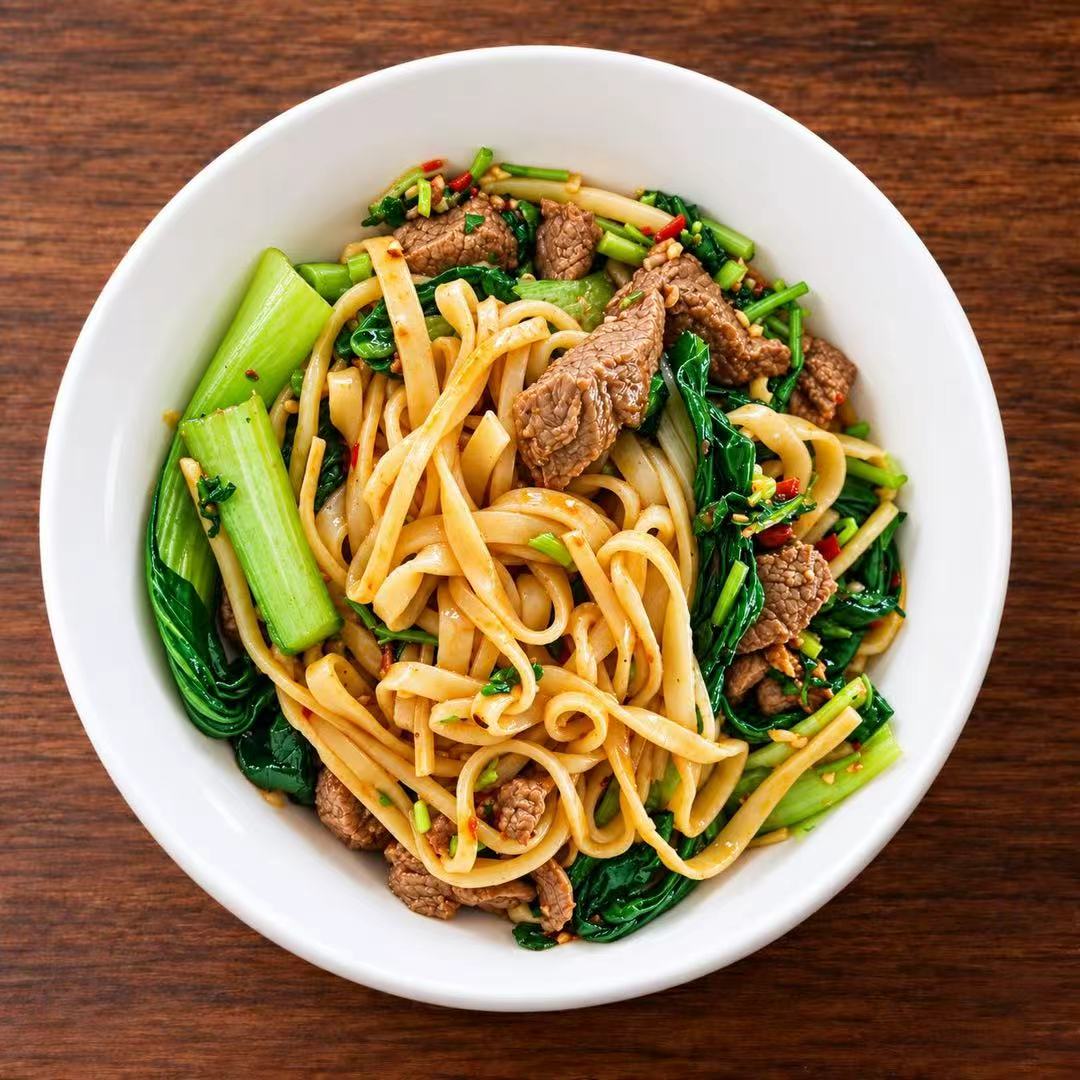 Stir-fried beef wide noodles with vegetables and chili