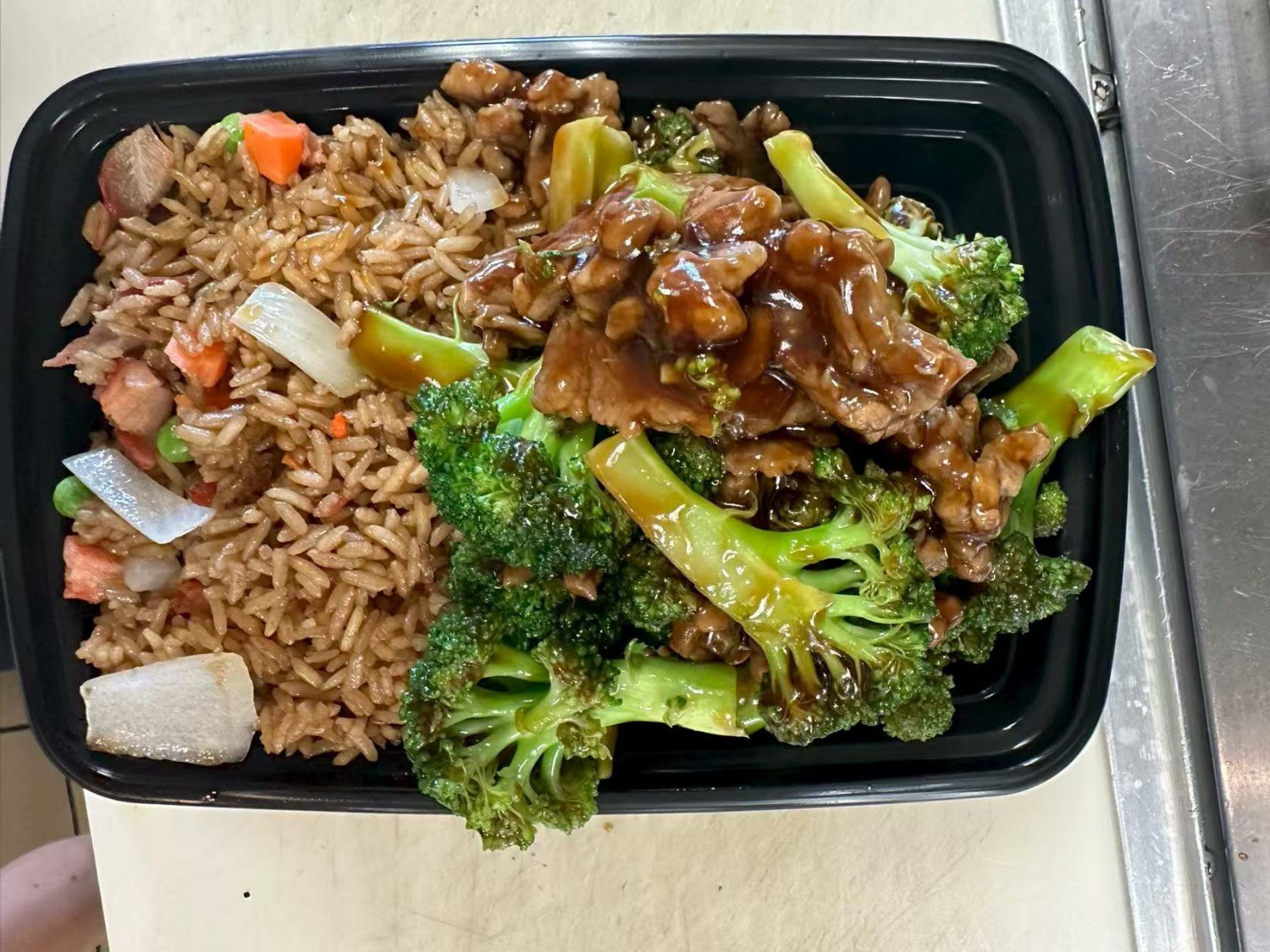 Tender beef with broccoli served alongside flavorful fried rice at Taste of China,a Chinese restaurant in Raleigh.
